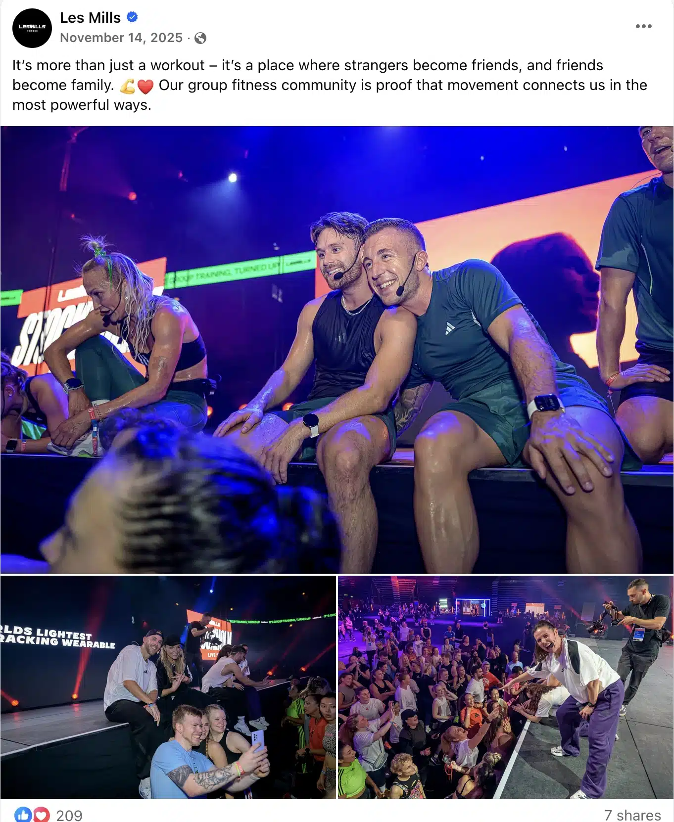 Facebook post by Les Mills showing instructors and participants resting and smiling on a stage after a high-energy group fitness class, with additional photos of trainers taking selfies and interacting with a cheering crowd, highlighting the community atmosphere of a live workout event.