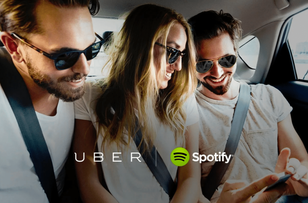 3 people in an uber scrolling through their spotify playlist