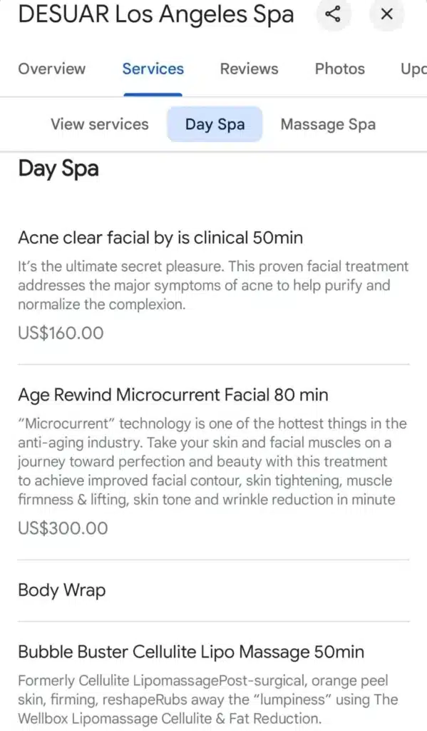 Service listings from DESUAR Los Angeles Spa under the Day Spa category, showing prices and descriptions for treatments such as Acne Clear Facial, Age Rewind Microcurrent Facial, Body Wrap, and Bubble Buster Cellulite Lipo Massage.