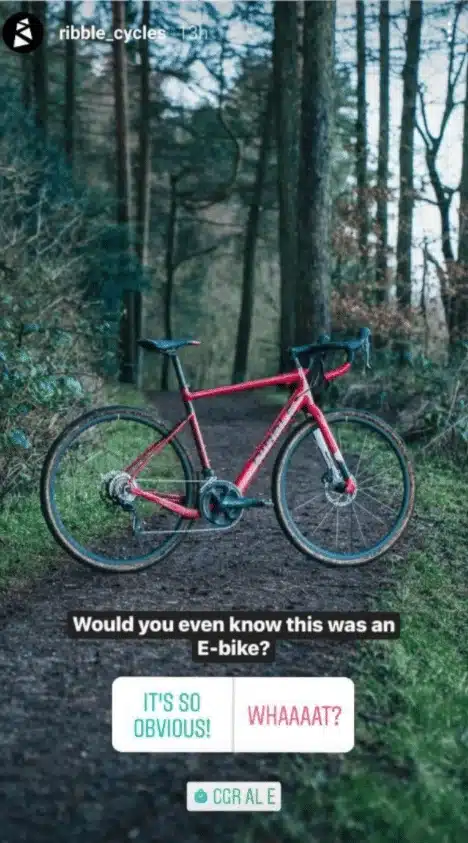 Instagram story by @ribble_cycles showing a red and black e-bike in a forest with the question “Would you even know this was an E-bike?” Below are two poll options: “IT’S SO OBVIOUS!” and “WHAAAT?”