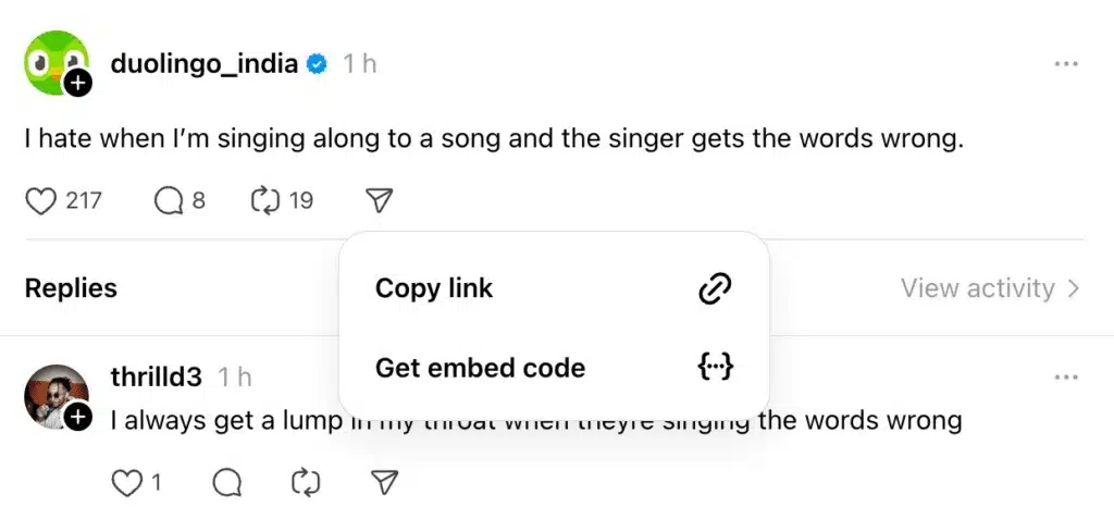 Threads post by Duolingo with a visible reply and a pop-up menu offering options to Copy link or Get embed code.