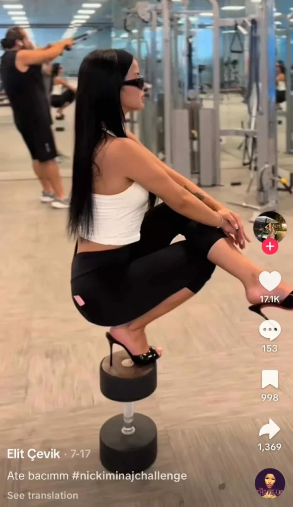 TikTok trend #nickiminajchallenge: Woman squatting on a dumbbell in heels at the gym.