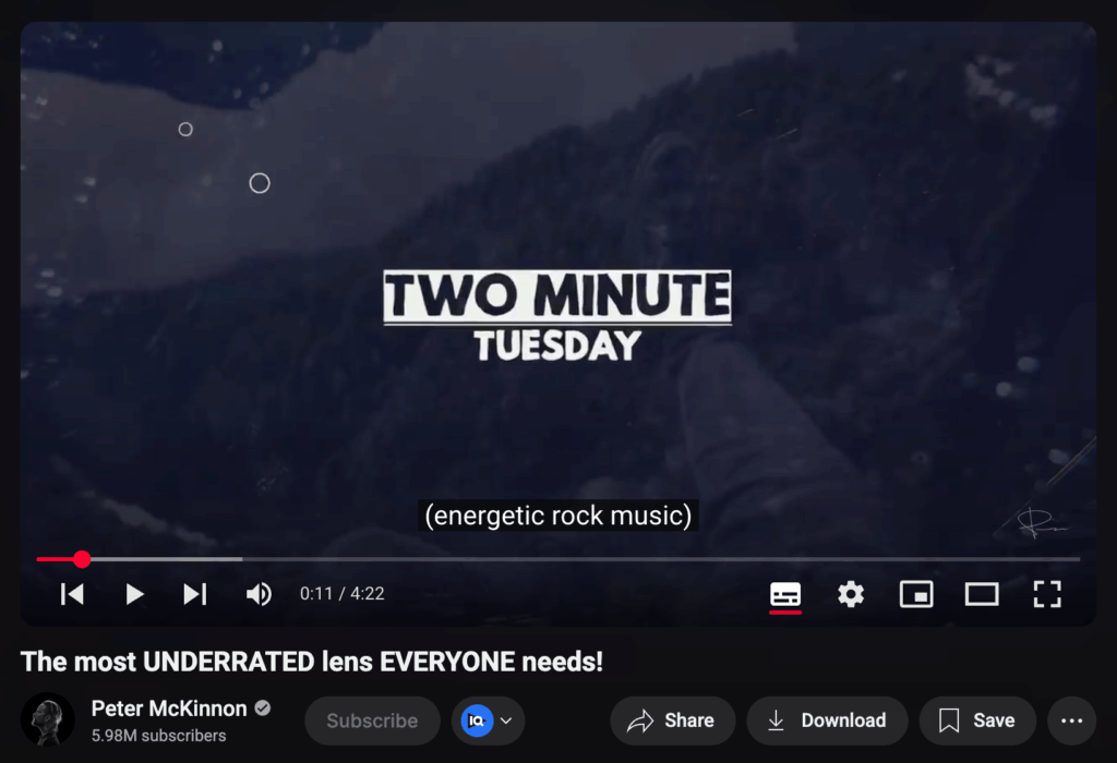 YouTube video screenshot from Peter McKinnon's channel showing the intro screen with bold text 'TWO MINUTE TUESDAY' over a dark, mountainous background. The subtitle at the bottom reads '(energetic rock music).