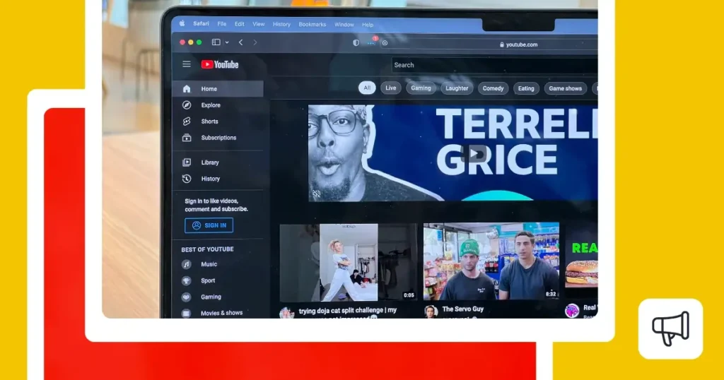 Laptop screen open to YouTube’s homepage showing the navigation menu on the left, search bar at the top, and video recommendations.