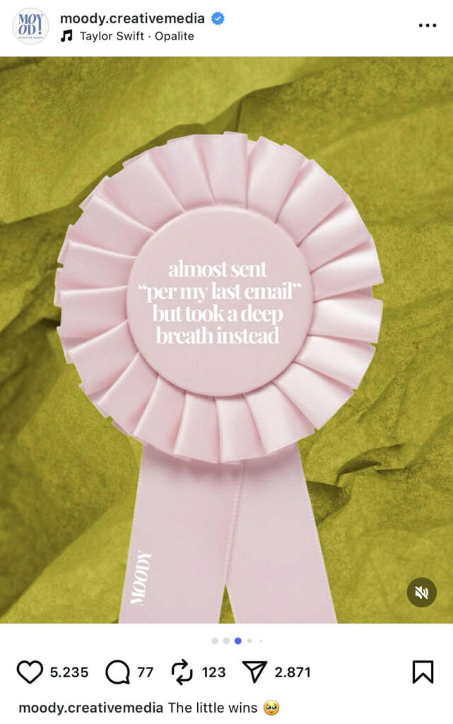 A pink rosette ribbon with layered pleats is displayed against a crumpled green background. The center of the ribbon has white text that reads:“almost sent ‘per my last email’ but took a deep breath instead.”