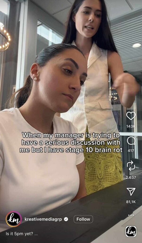 Instagram Reel showing two women in an office setting — one sitting at a desk looking tired and disengaged, while the other stands beside her gesturing mid-conversation. The on-screen text reads, “When my manager is trying to have a serious discussion with me but I have stage 10 brain rot.”