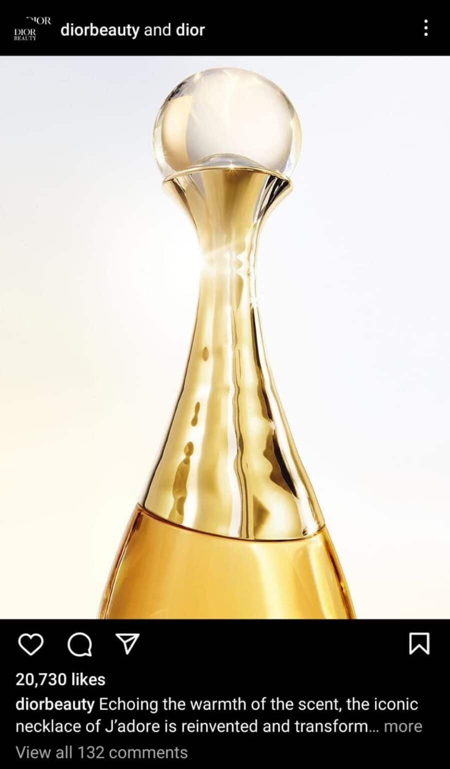Instagram collab post between Dior Beauty and Dior featuring a close-up of the luxurious golden J’adore perfume bottle, with soft lighting highlighting its elegant curves and shimmering finish.