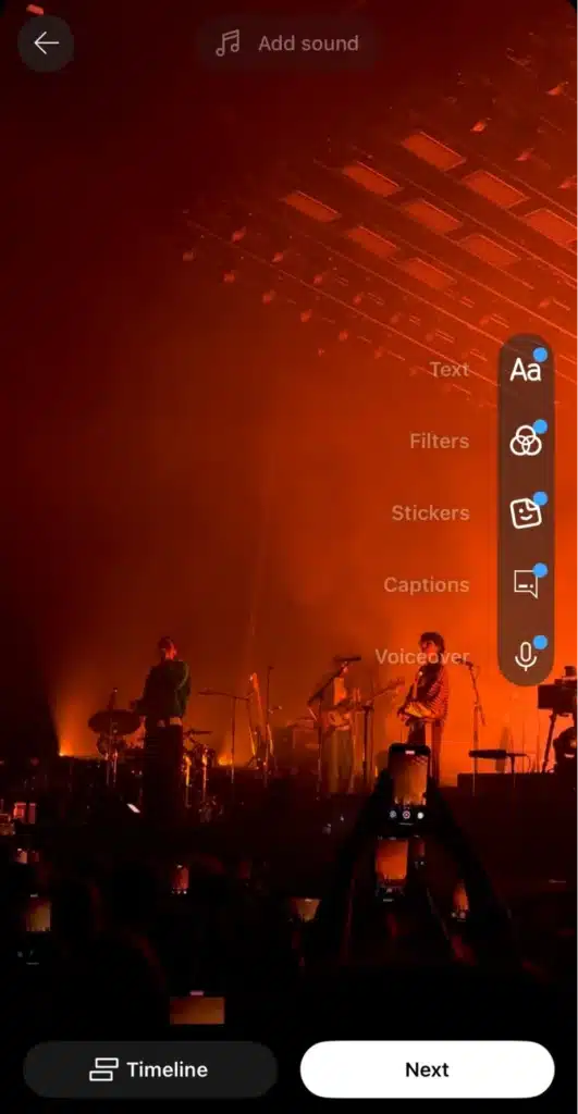 YouTube Shorts mobile editing screen showing a concert video with options to add text, filters, stickers, captions, and voiceover before posting.