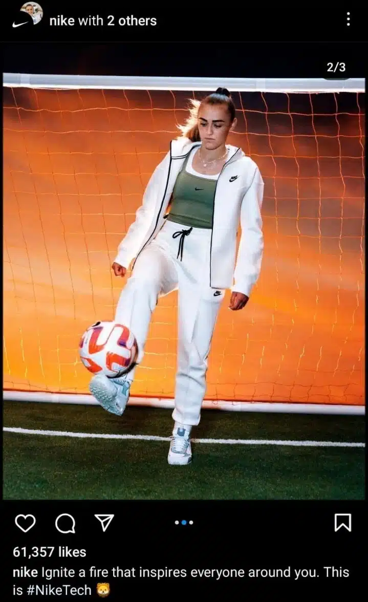 Instagram collab post by Nike featuring a female athlete in white Nike tracksuit juggling a soccer ball on a turf field with a glowing orange net background, promoting the #NikeTech collection.