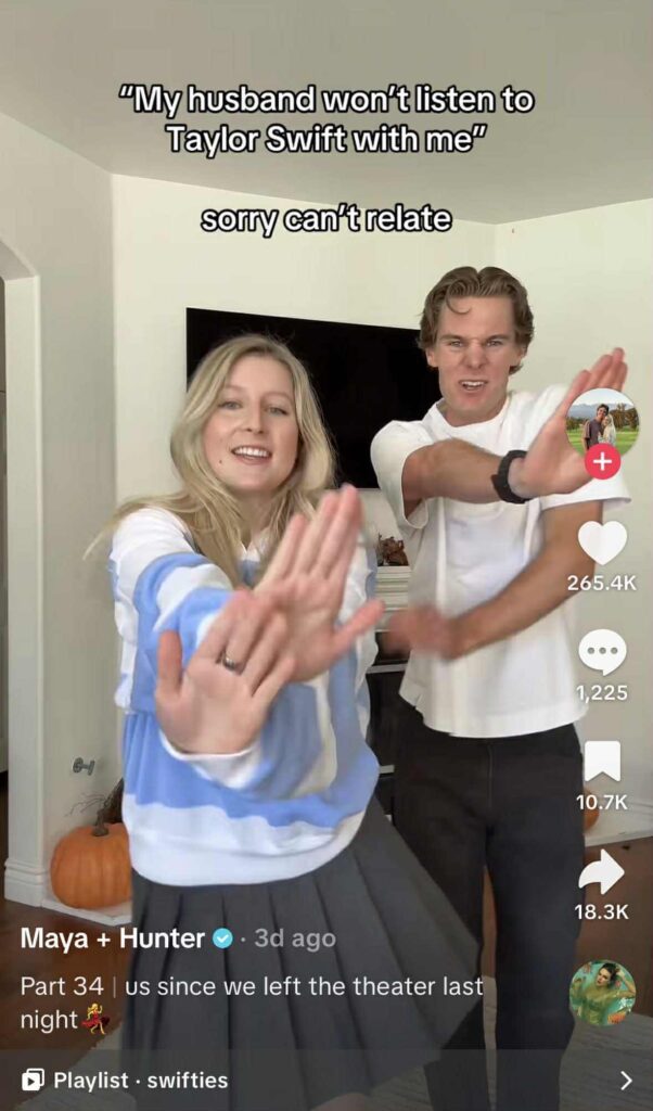 A couple dances enthusiastically in their living room with the text “My husband won’t listen to Taylor Swift with me — sorry can’t relate” displayed above them.