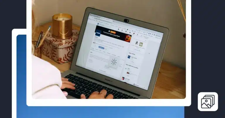A person works on a laptop at a wooden desk, viewing a LinkedIn page on the screen. A candle, pens, and a decorative box sit beside the computer.