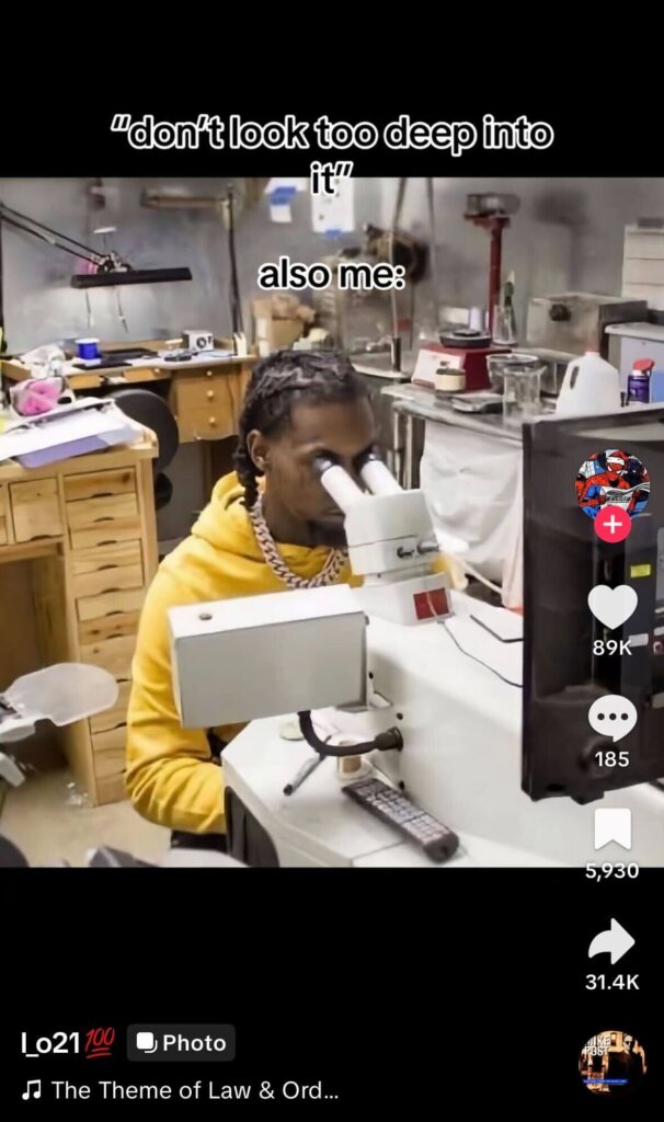 Person in a workshop peering into a microscope with meme text about “don’t look too deep into it,” implying overthinking.