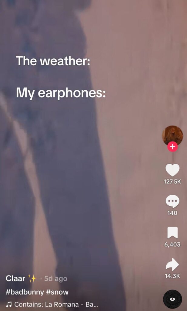 Blurry outdoor scene with muted colors and on-screen text reading, “The weather: My earphones:,” implying dramatic music against dull weather.
