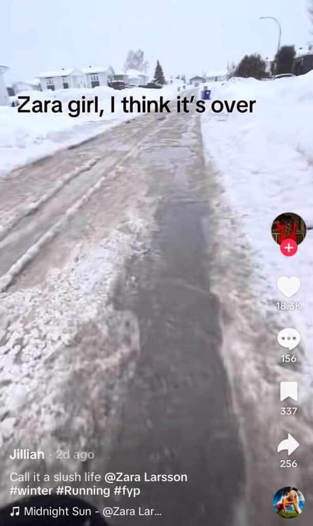 Slushy, snow-covered residential street filmed from a walking perspective, with on-screen text reading, “Zara girl, I think it’s over.”