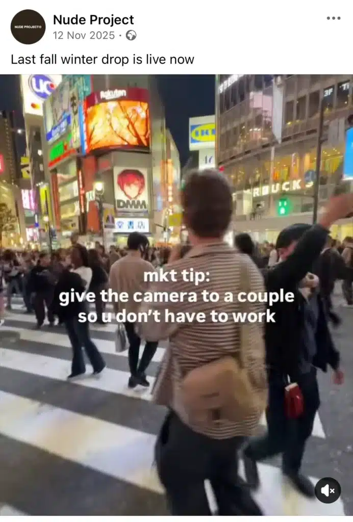 Video still of a crowded city crossing at night with text overlay reading ‘mkt tip: give the camera to a couple so u don’t have to work,’ shared by Nude Project.