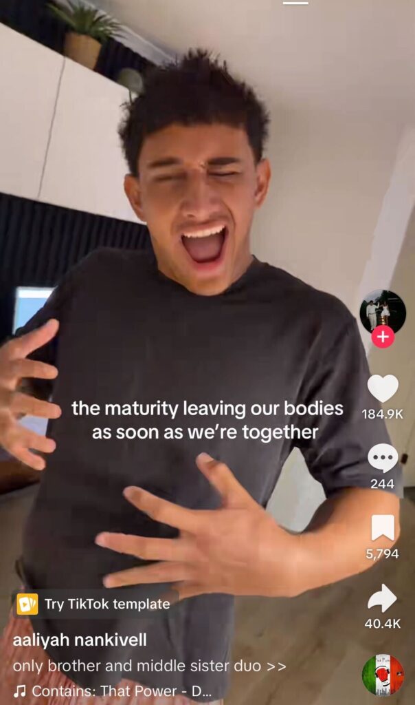 Young man laughing and gesturing dramatically, joking about losing maturity with siblings.