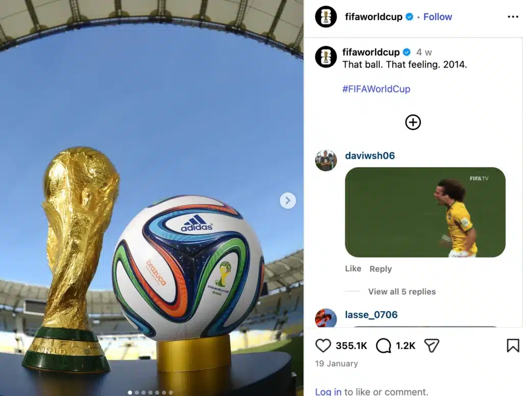 Instagram post from @fifaworldcup showing the FIFA World Cup trophy beside the official 2014 Adidas Brazuca match ball inside a stadium under a blue sky, with caption text referencing the 2014 World Cup.