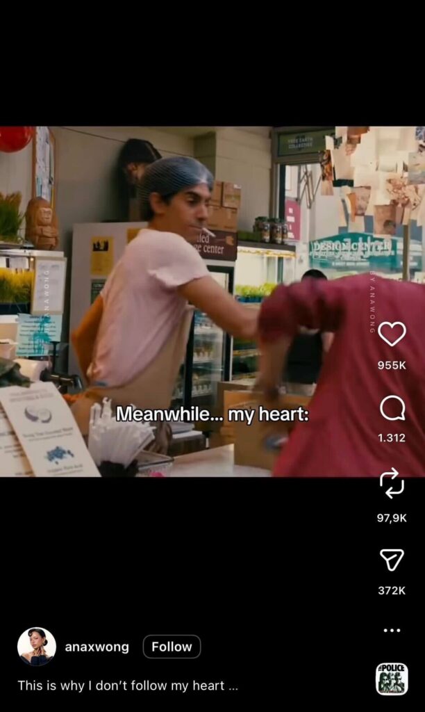 Barista playfully hitting a coworker behind a café counter in a humorous Instagram Reel with the caption “Meanwhile… my heart”