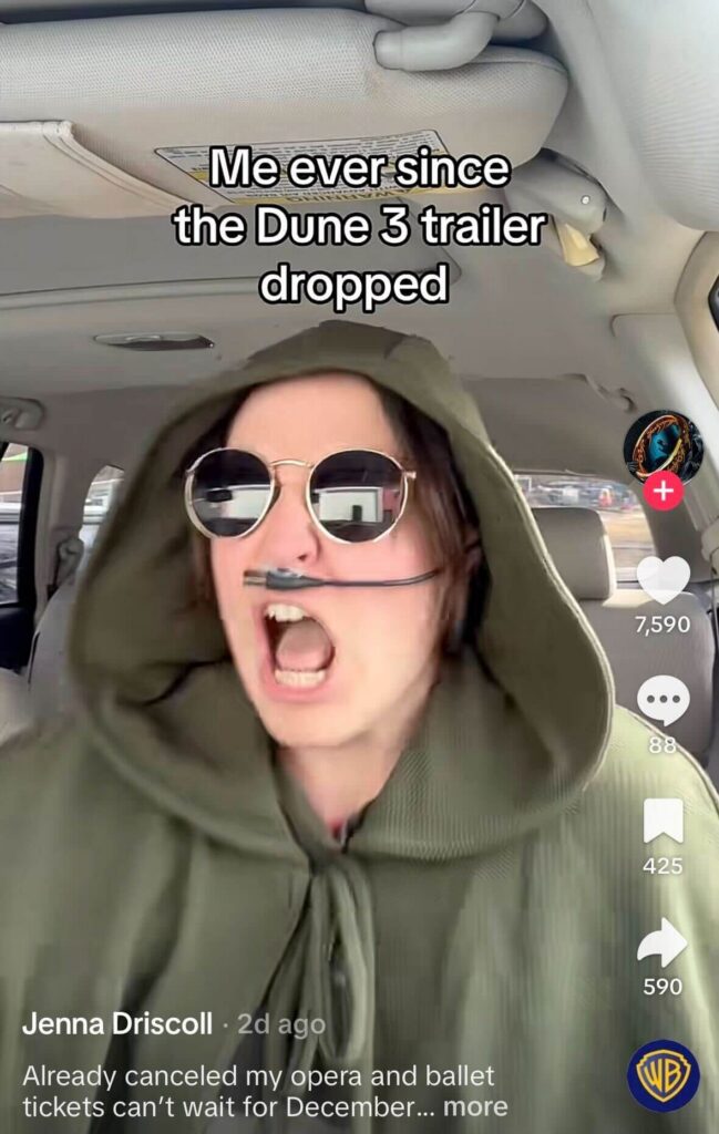 Person in a car wearing a green hood and round sunglasses shouting dramatically with text overlay about the “Dune 3 trailer,” shown in a TikTok interface.