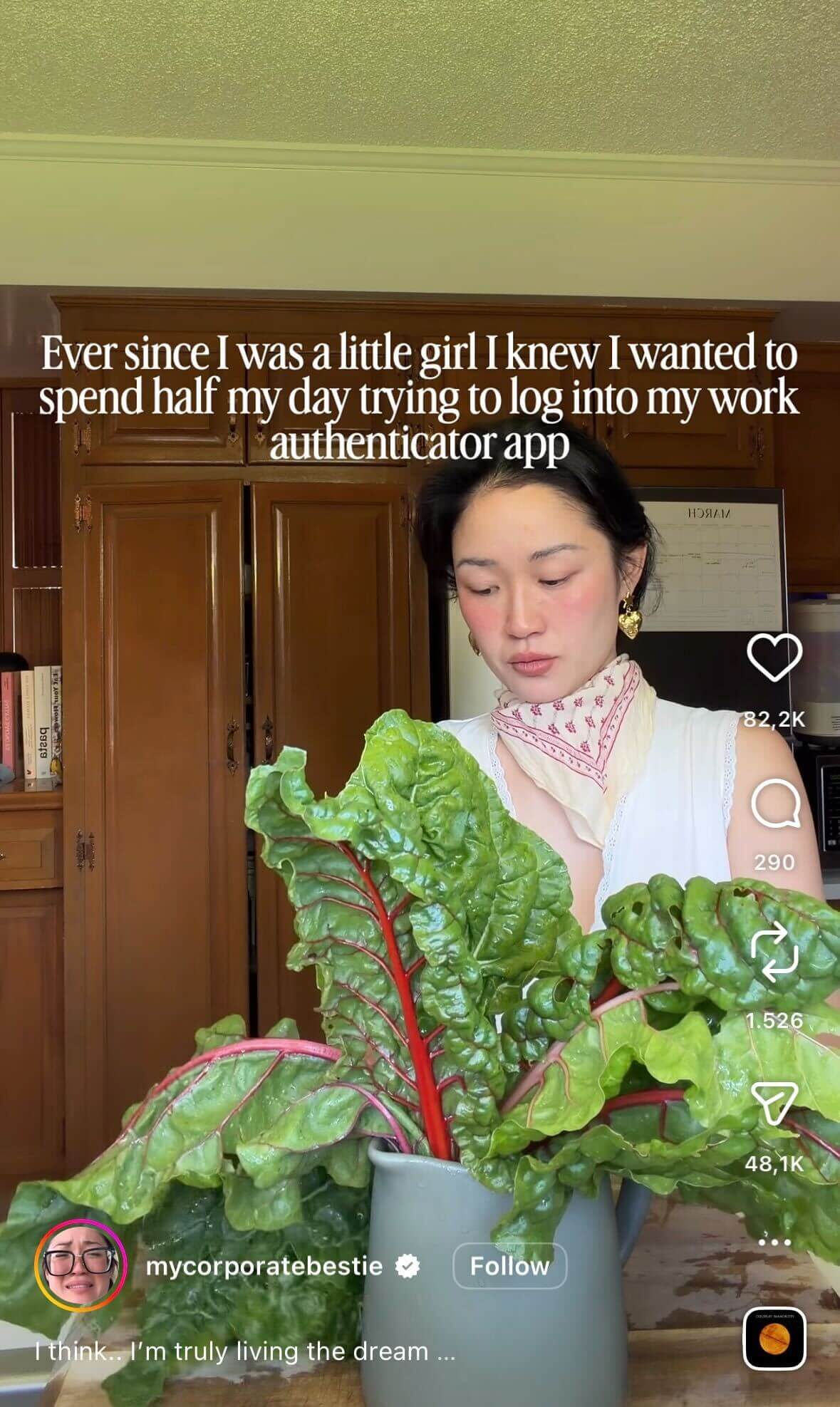 Woman in a kitchen holding large leafy greens (Swiss chard) with wooden cabinets in the background; overlaid text reads “Ever since I was a little girl I knew I wanted to spend half my day trying to log into my work authenticator app.”
