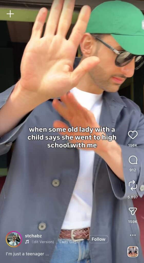 Man wearing sunglasses and a green cap raises his hand to block the camera, with text overlay about an awkward moment when someone claims they went to high school with him.