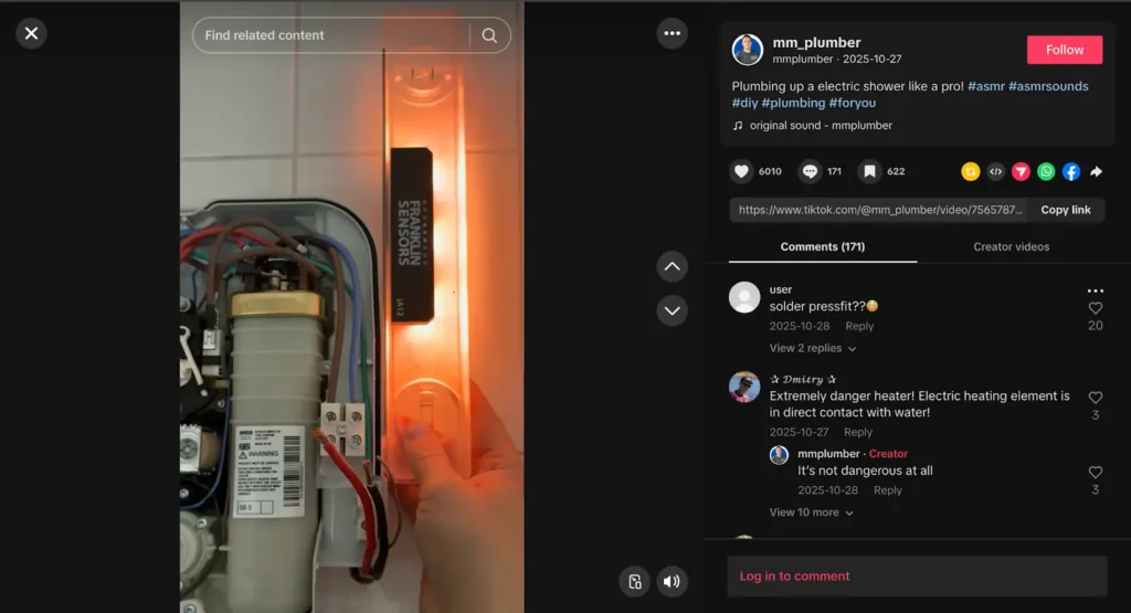 Close-up of an open electric shower unit with exposed wiring and a glowing tester tool during a repair demonstration.