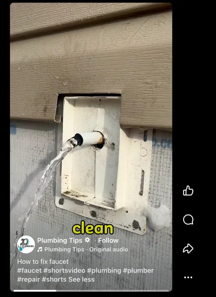 Water flowing from a short exterior pipe outlet on a house wall, featured in a plumbing tips video about fixing faucets.