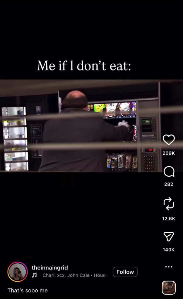 Man aggressively shakes a vending machine in a dimly lit hallway, with text overlay reading “Me if I don’t eat,” illustrating a humorous hunger reaction.