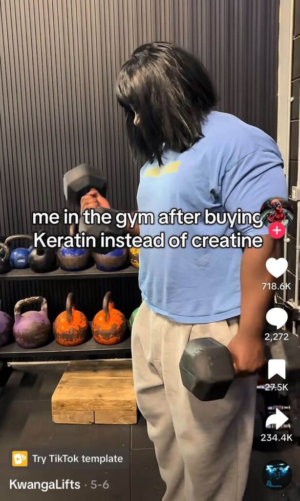 Person lifting dumbbells in a gym surrounded by kettlebells; overlaid text reads “me in the gym after buying Keratin instead of creatine.”