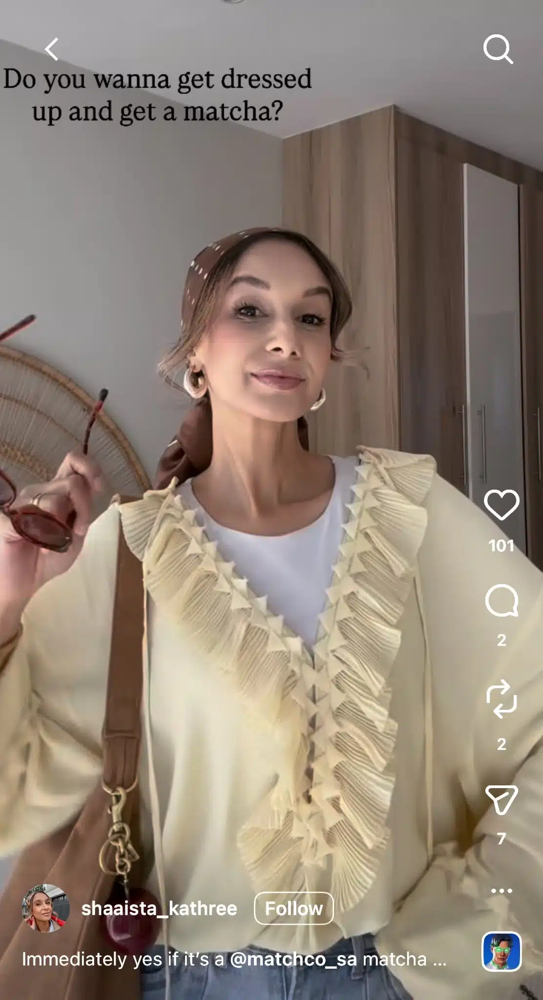 Instagram Reel from @shaaista_kathree showing a woman in a cream ruffled blouse and brown headscarf holding sunglasses, with on-screen text reading “Do you wanna get dressed up and get a matcha?” and the Reel interface displaying engagement metrics and follow button.