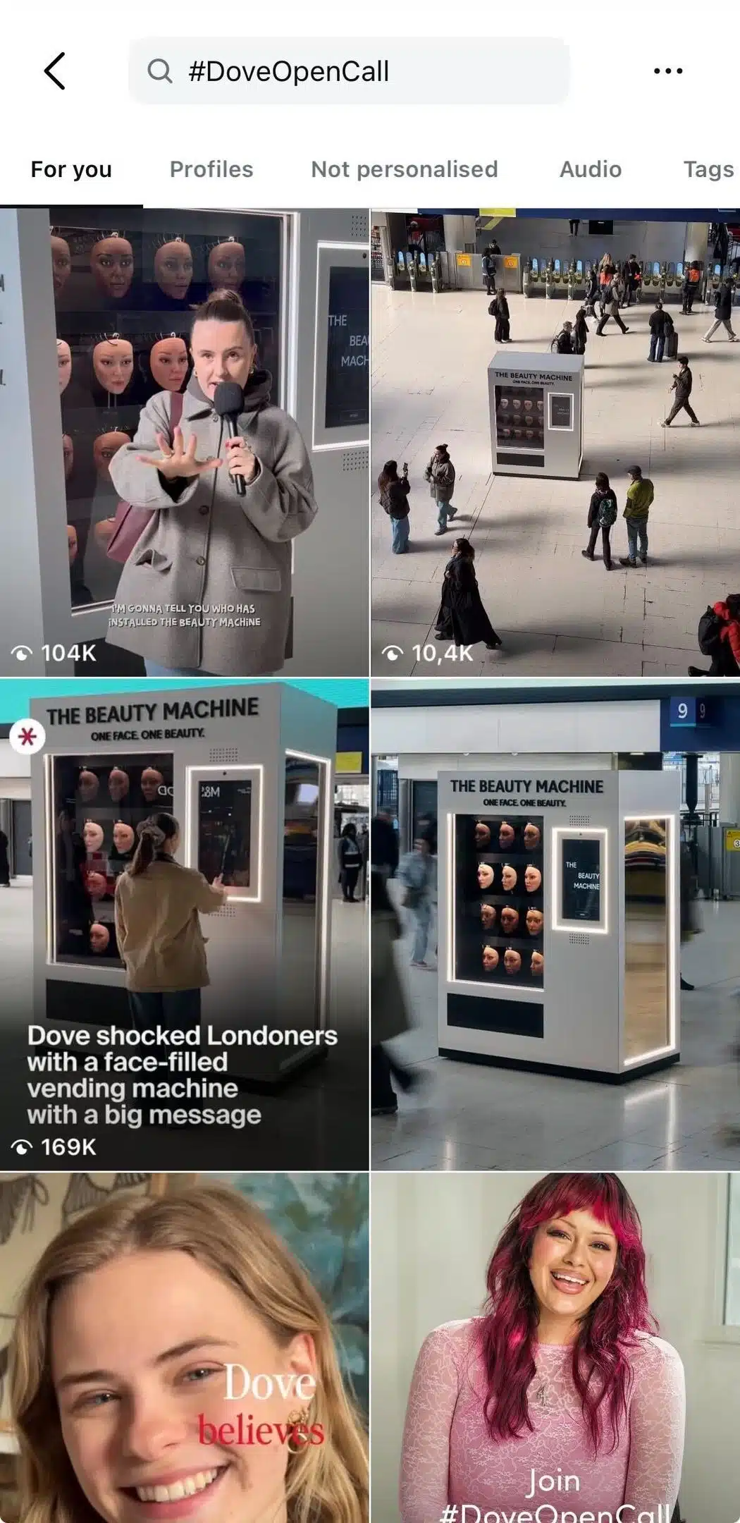 Instagram search results page for the hashtag #DoveOpenCall. The grid displays videos and images from Dove’s campaign, including a woman speaking in front of an installation called “The Beauty Machine,” wide shots of the installation in a public transit station, and close-up portraits of diverse women. The interface shows search tabs including “For you,” “Profiles,” “Not personalised,” “Audio,” and “Tags.”