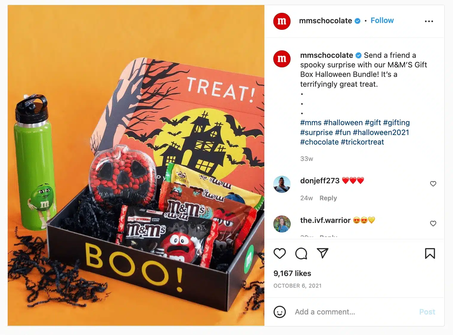 Product-focused Instagram post on an orange background featuring a Halloween-themed gift box filled with M&M’s candy packs and seasonal treats. The box is decorated with a haunted house illustration and the word “TREAT!” on the lid. A green M&M’s-branded water bottle stands beside the gift box. Instagram interface and caption panel visible.