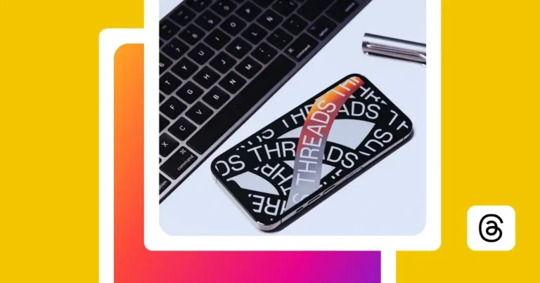 Social media app icons and a smartphone displaying the Threads logo and branding next to a laptop keyboard on a desk, illustrating the Threads social media platform and its connection to Instagram.