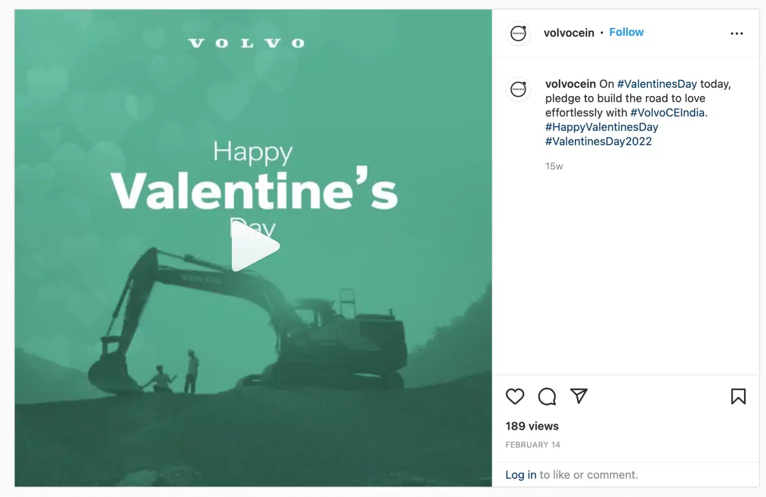 Instagram video thumbnail with a teal-green background and faint heart shapes throughout. White text reads “Happy Valentine’s Day.” In the foreground, the silhouette of an excavator is positioned so its bucket appears to interact with two small human figures standing nearby, creating a romantic visual scene. Volvo branding appears at the top.