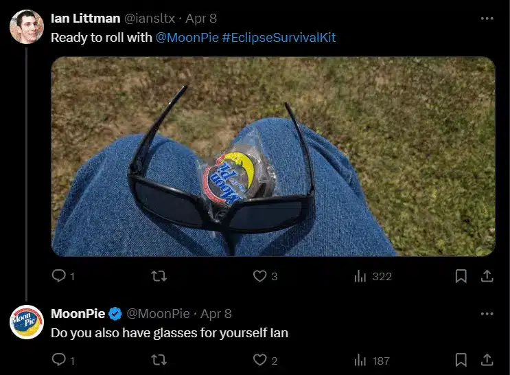 X conversation showing a customer post about a MoonPie Eclipse Survival Kit. The customer shares a photo of eclipse glasses resting on their lap with a MoonPie snack placed between the lenses. Below, the verified MoonPie account replies, "Do you also have glasses for yourself Ian," demonstrating the brand responding to a customer's post with humor.