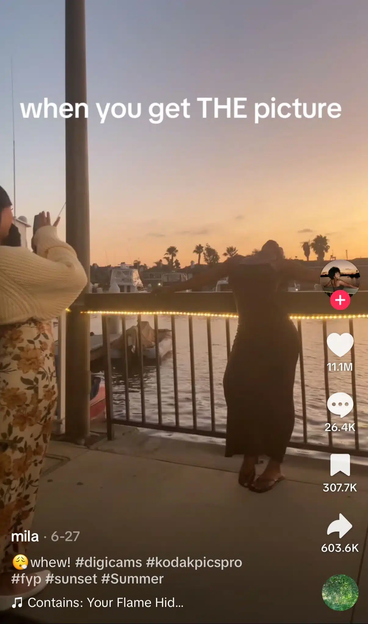 TikTok using the viral "when you get THE picture" trend. A person poses by a waterfront at sunset while another person takes their photo. The trend celebrates finally capturing the perfect photo after multiple attempts.