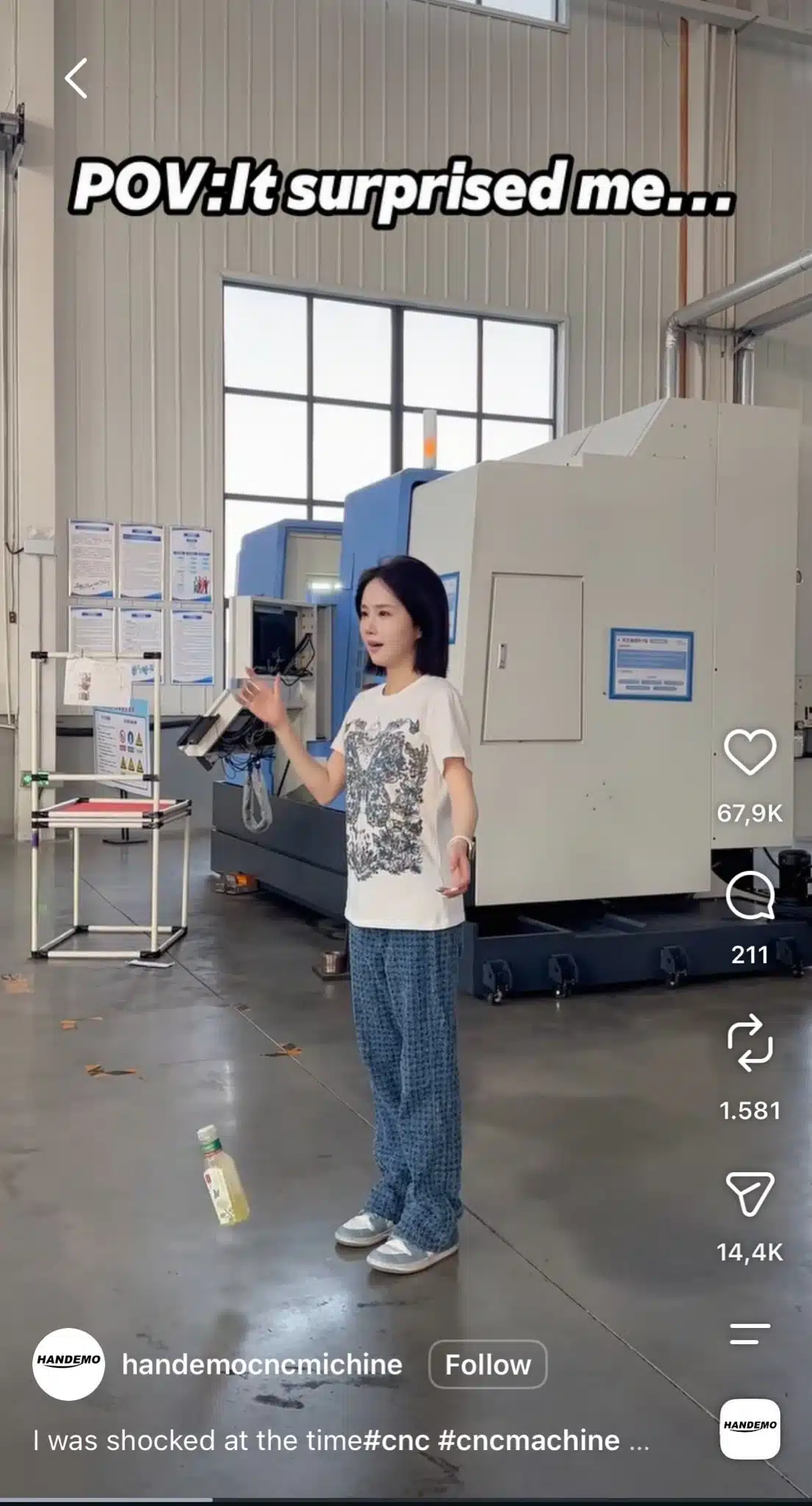 Woman standing in front of industrial machinery with on-screen text reading “POV: It surprised me…,” as part of the “Give It Up to Me” TikTok trend.