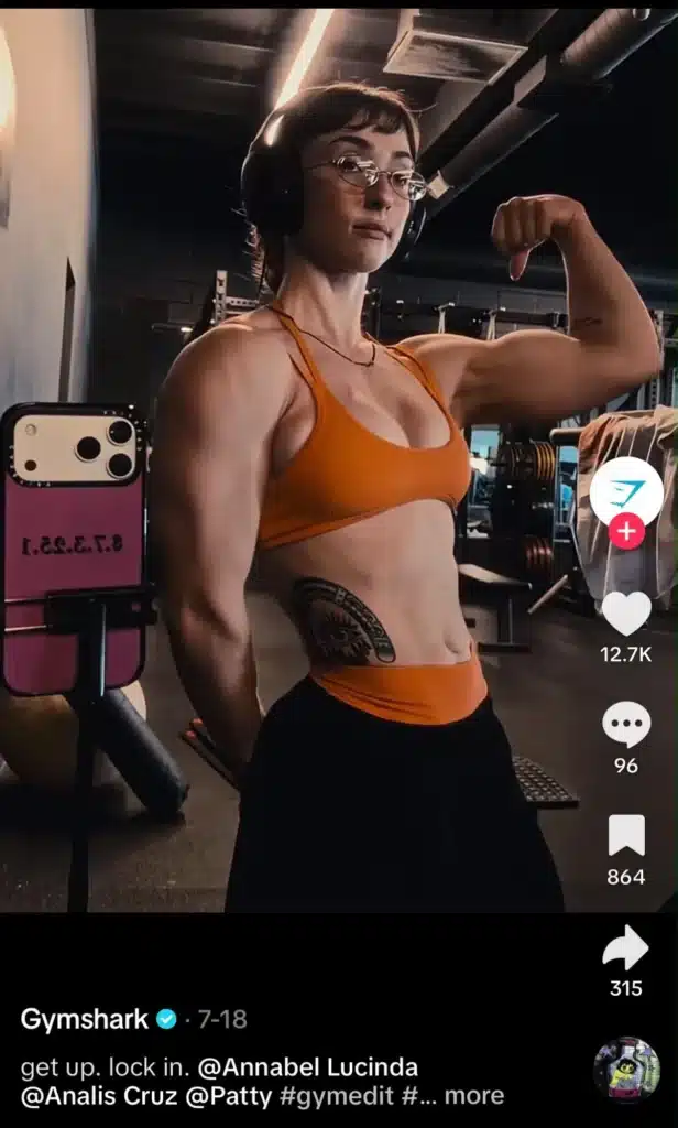 Fitness creator flexing in a Gymshark TikTok video, showcasing workout progress and gym apparel.