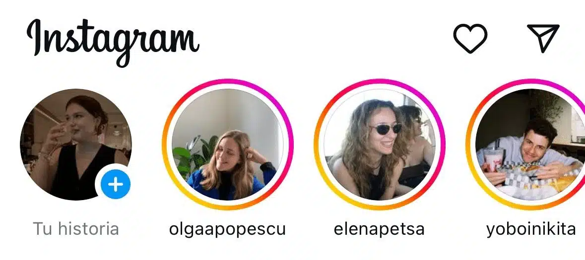 Instagram home screen displaying the Stories row across the top, including the user's story with the add button and several stories from followed accounts highlighted with colorful rings indicating new updates.