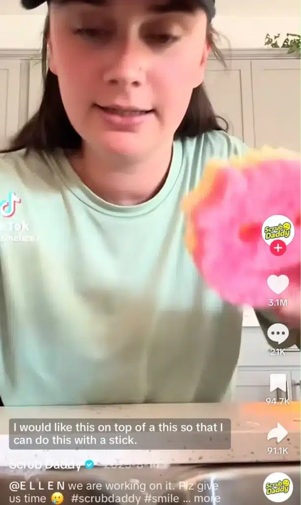 TikTok creator demonstrating a Scrub Daddy sponge while suggesting a new product feature.