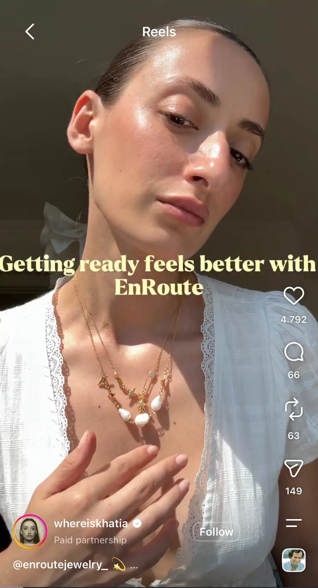 Instagram Reel from whereiskhatia featuring a close-up of layered necklaces in a paid partnership with EnRoute Jewelry, with text reading, “Getting ready feels better with EnRoute.”