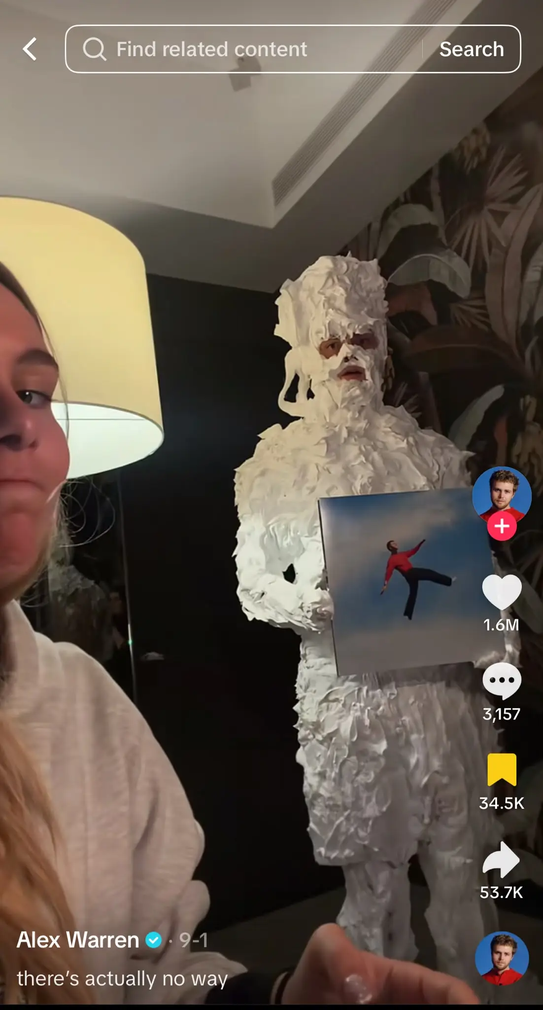 TikTok video showing a person covered from head to toe in shaving cream while holding up a reference photo, as part of the shaving cream prank trend.