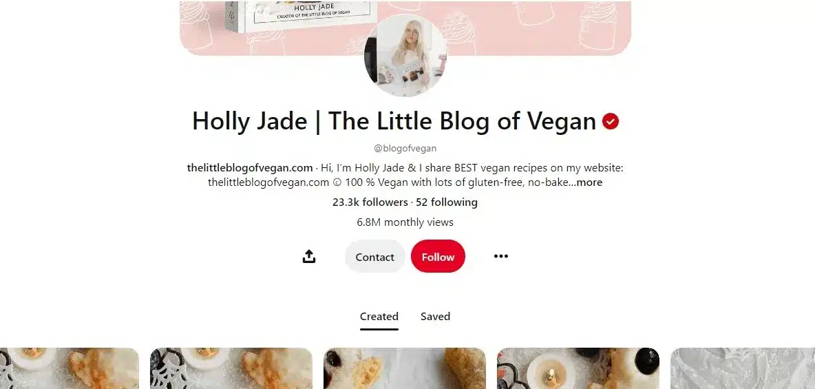 Pinterest profile page for “Holly Jade | The Little Blog of Vegan,” featuring a pink branded banner, profile photo, verified badge, and the handle @blogofvegan. The bio promotes vegan recipes, including gluten-free and no-bake options. The profile shows 23.3K followers, 52 following, 6.8 million monthly views, Contact and Follow buttons, and tabs for Created and Saved pins, with food-themed pin thumbnails along the bottom.